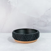 "Empty PEAK bowl planter front view, displaying wood base with striking carbon fibre pattern."